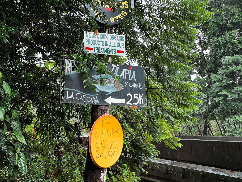 Signage on the road for Restaurante Tilapia and La Cascada.