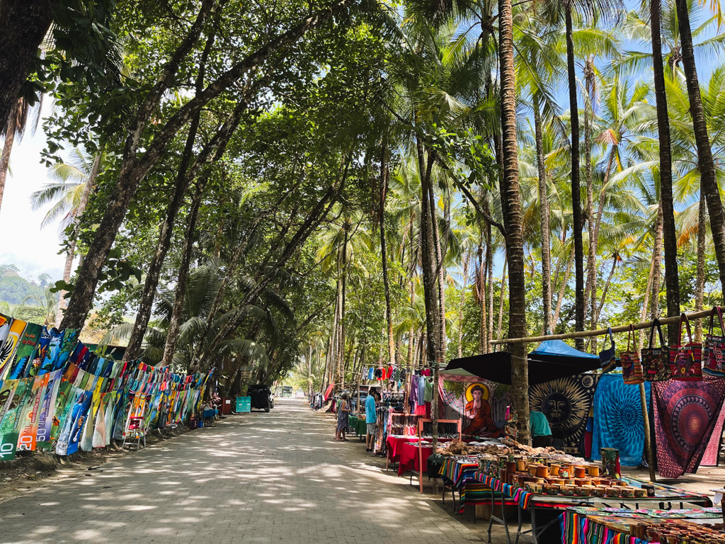 Street by the beach, lined with souvenir shops on either side, in Dominical, on the South Pacific coast of Costa Rica.