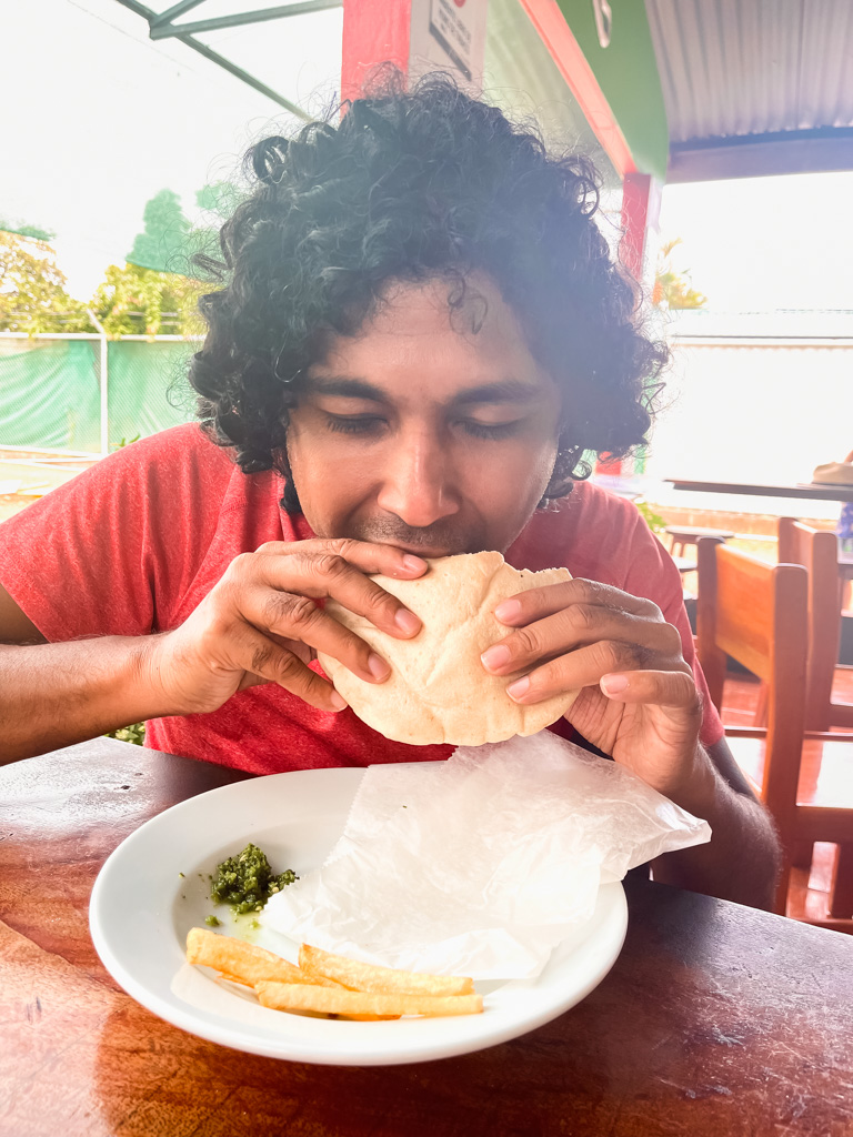 A man concentrating on his falafel pita at Falafel Uvita, a Middle Eastern restaurant in Uvita.