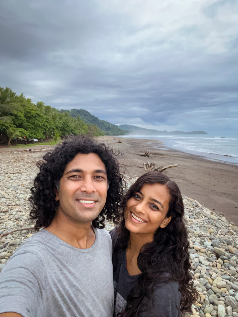 Selfie of Paradise Catchers couple at the Dominical beach, on their last afternoon of living by the beach in Dominical, Costa Rica.