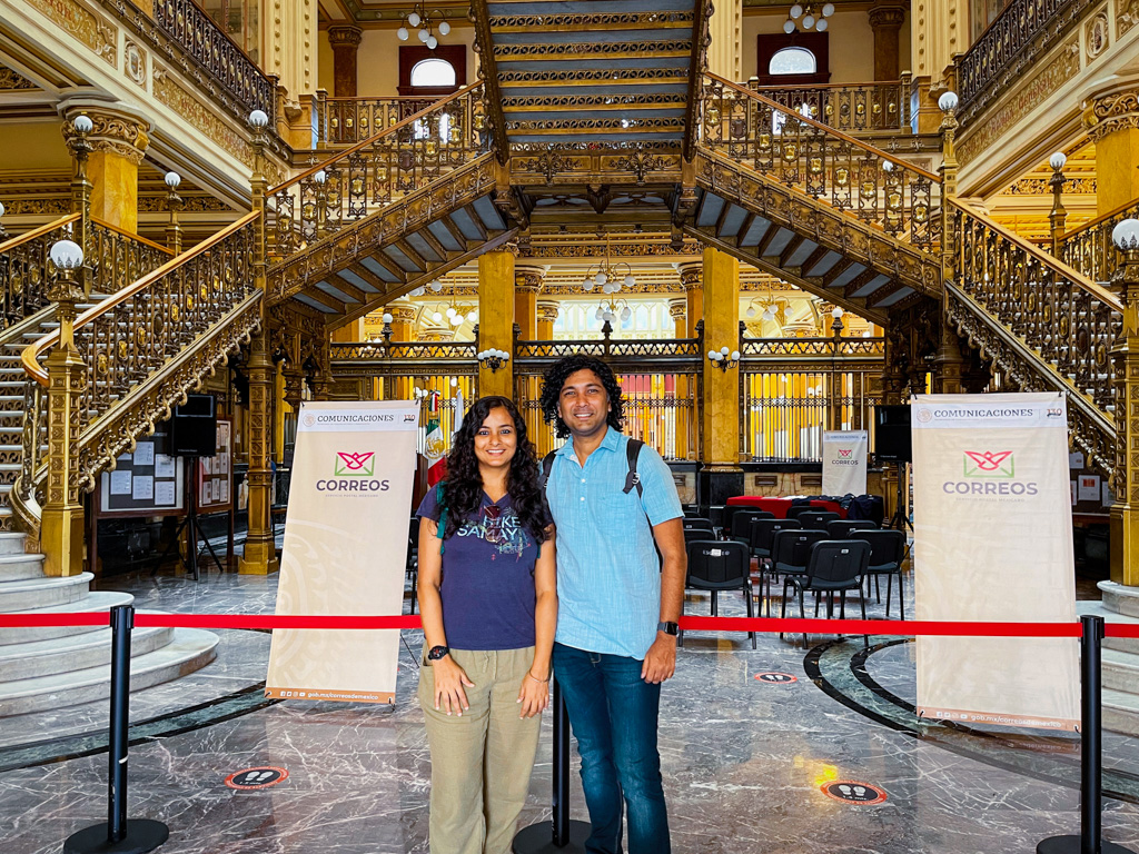 Couple standing inside the grand Palacio Postal.