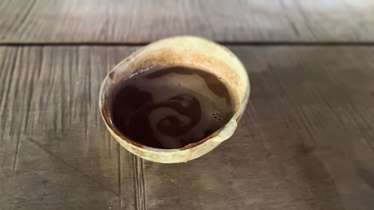 Liquid chocolate made from freshly roasted and crushed cacao beans, on a Bribri tour in Caribbean Costa Rica.