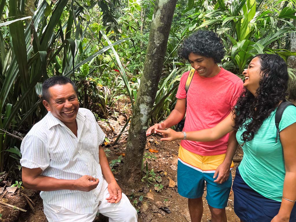 An Indian couple having a hearty interaction with a respected man from the indigenous Bribri community.