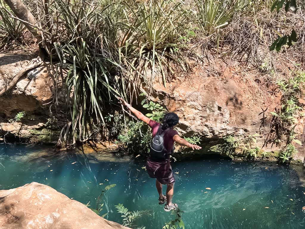 A man, about to make the splash in the river, Rio Blanco, during Catarata the waterfall hike in Costa Rica.