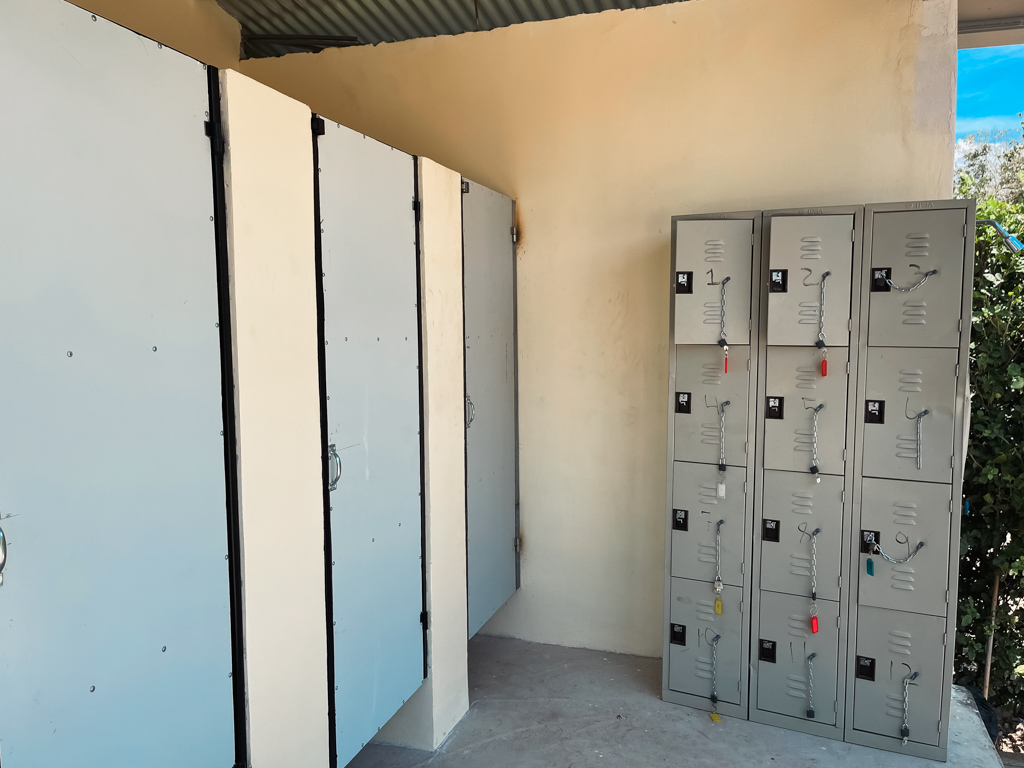 Lockers on the right, changing room doors to the left, at the reception office of La Leona Waterfall Adventure Hike.