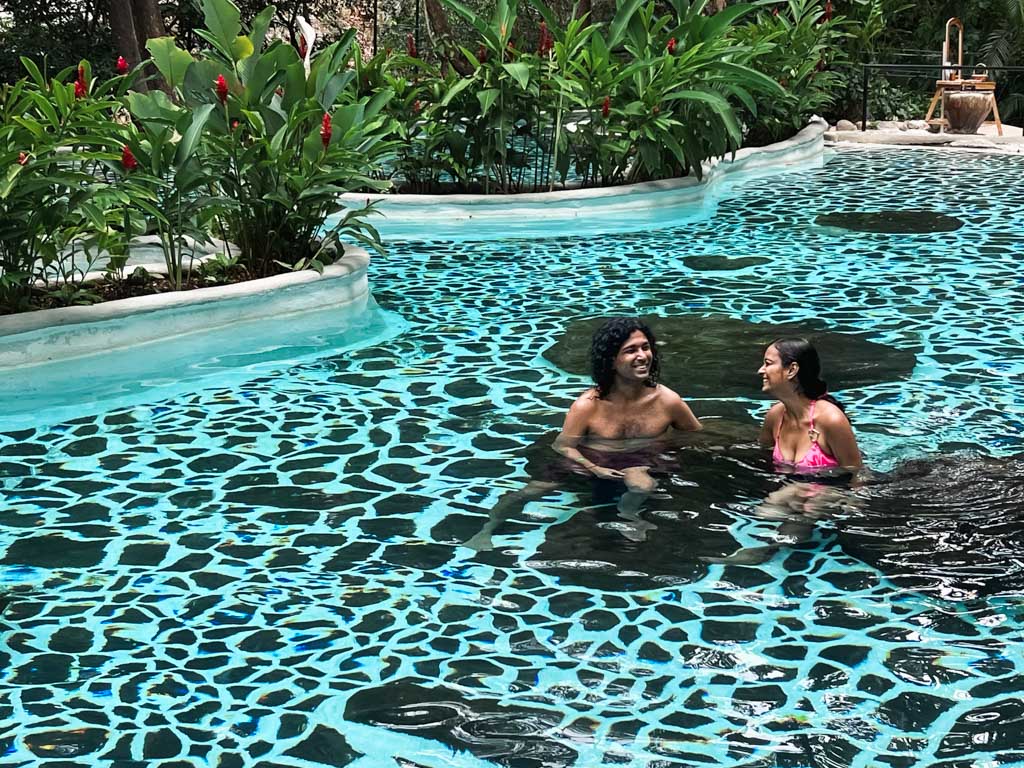 A man and a woman relaxing in the Vandara Hot Springs in Guanacaste, Costa Rica.
