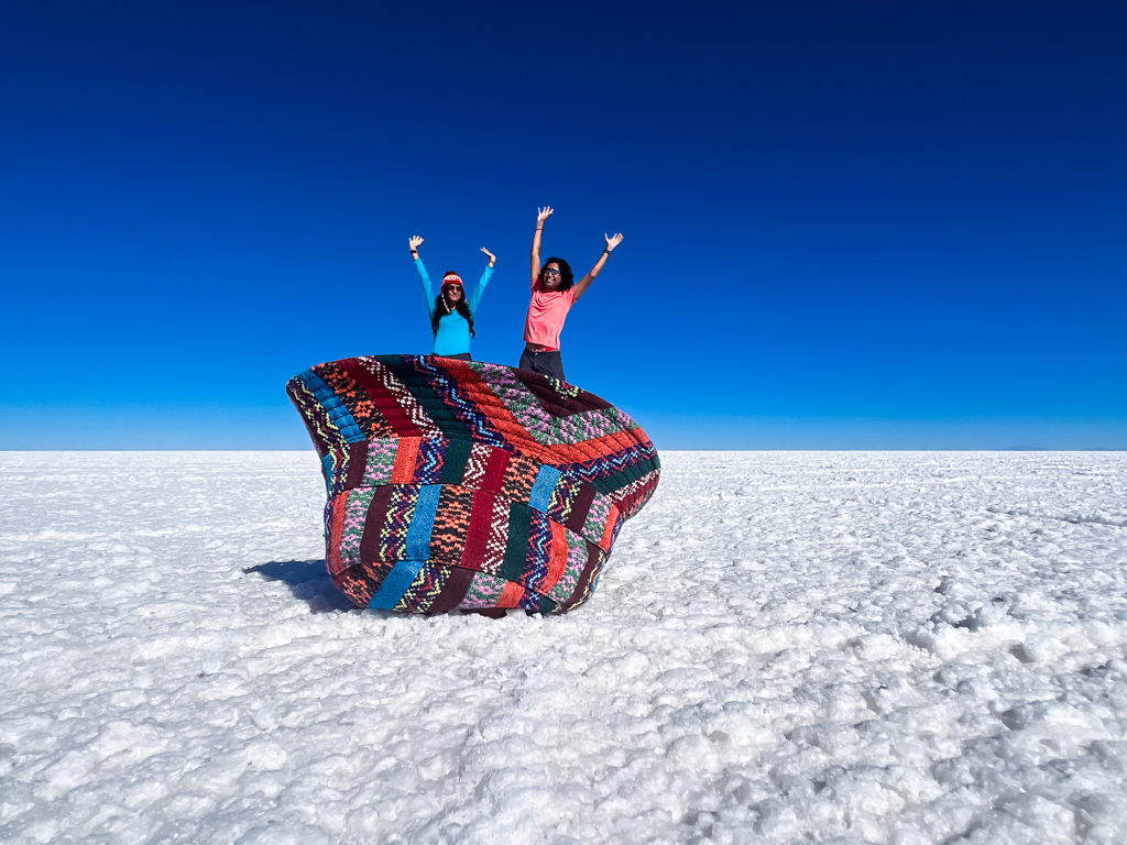 Perspective photo of a couple inside a hat, on the salt flats of Uyuni in Bolivia.