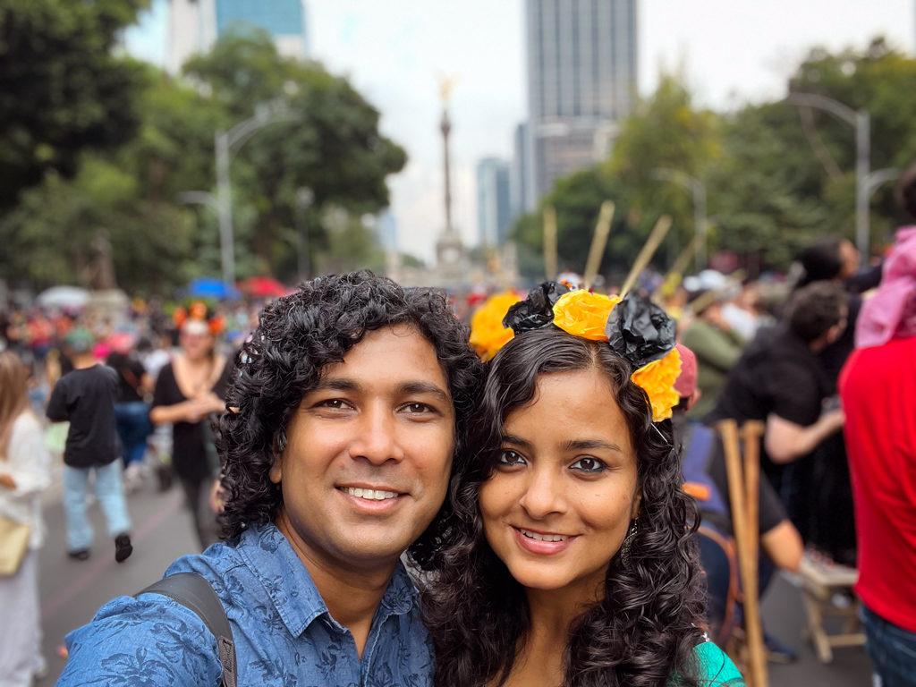 A man and a woman, at one of the Day of the Dead related parades in Mexico City.