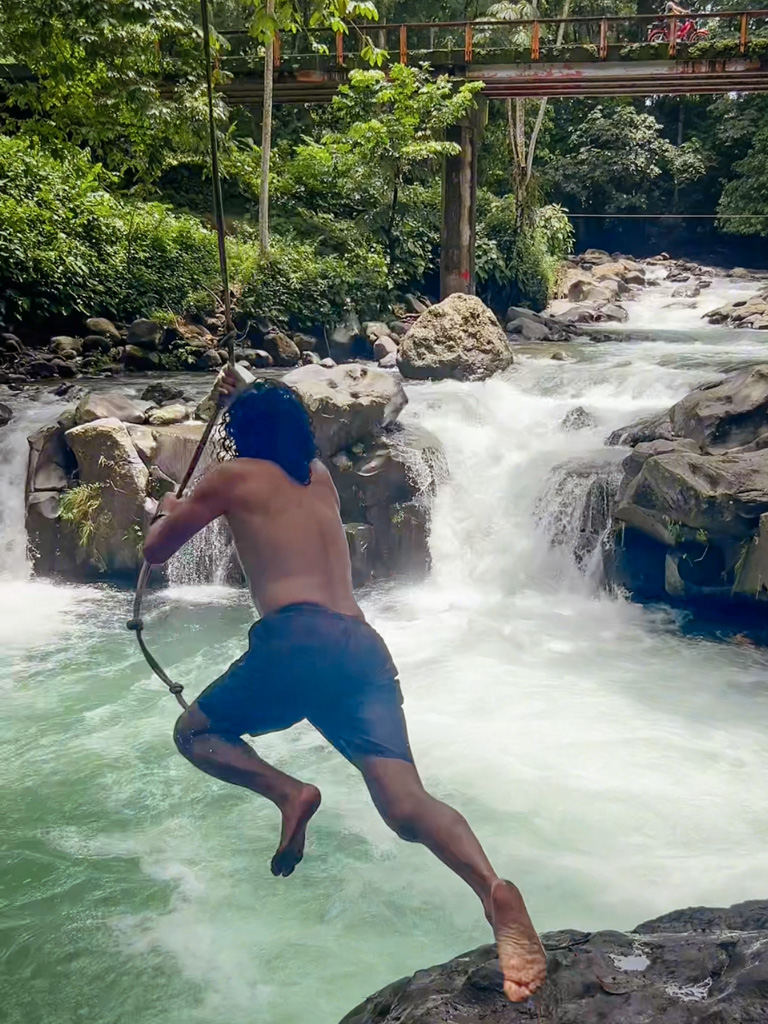 Diving into a river pool in La Fortuna, Costa Rica, El Salto Rope Swing.
