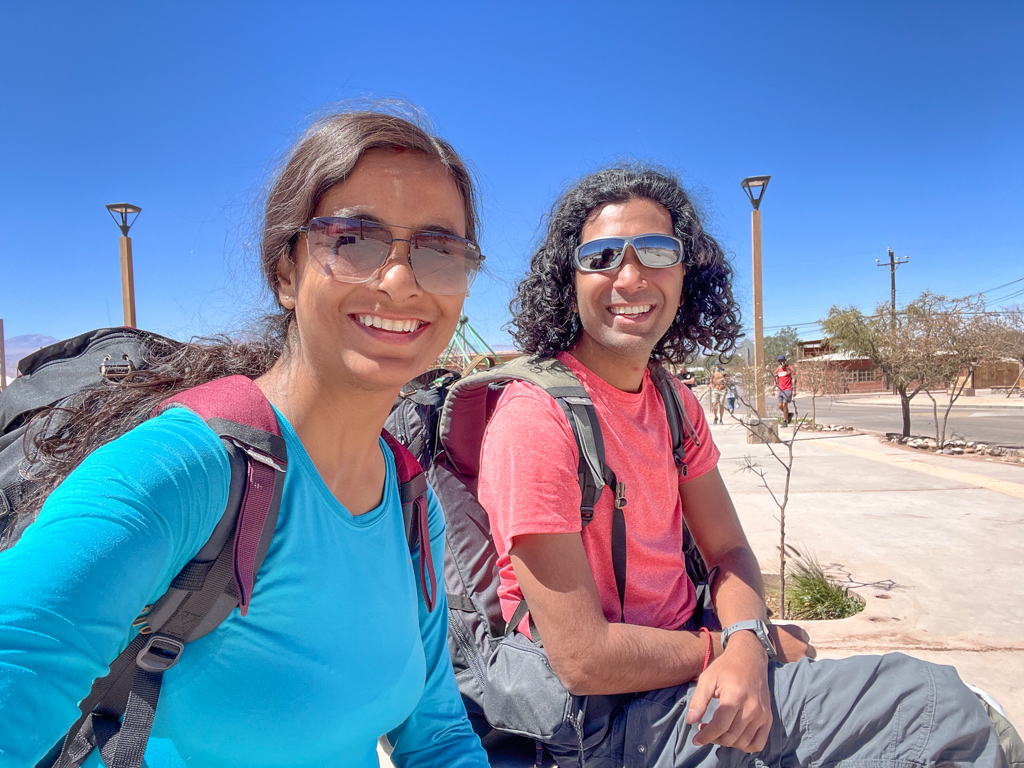 A woman and a man sitting on a street of San Pedro de Atacama, Chile.