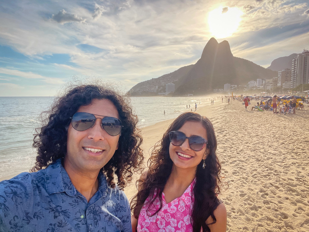 A couple at Leblon Beach, one of the best areas to stay in Rio de Janeiro.