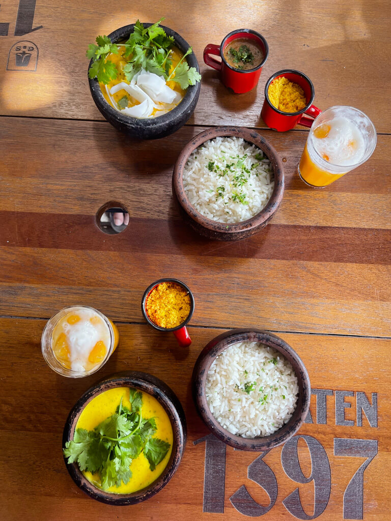 A flat lay photo of food and drinks on a table at a restaurant in Rio de Janeiro.
