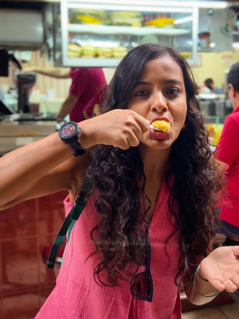 A woman trying the traditional Lolo Mora’s artisanal ice cream at the Central Market as part of the San Jose city walking tour.