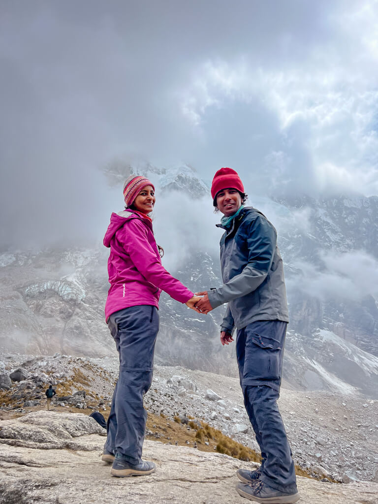 A man and a woman at the Salkantay Pass in Peru. Packing List for Salkantay Trek.