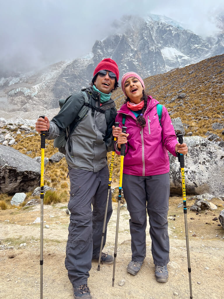 A man and a woman posing as tired trekkers during their Salkantay Trek.