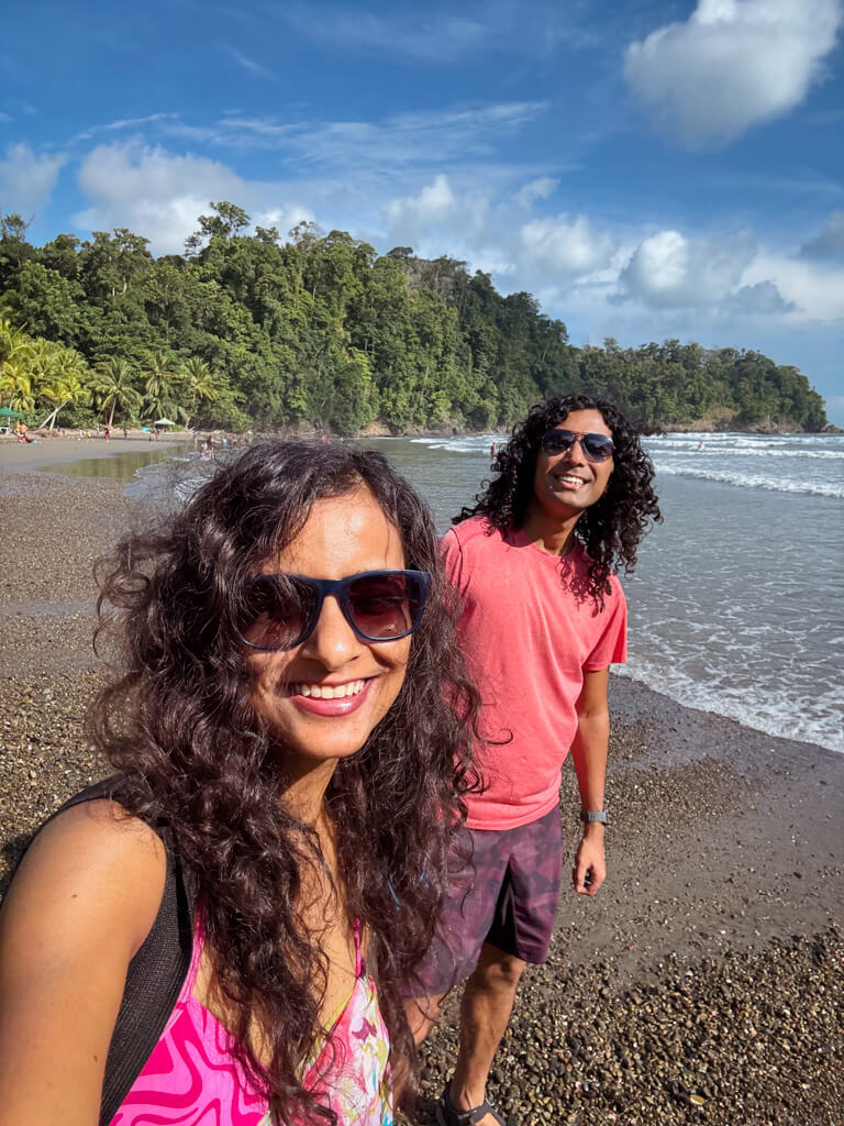 A woman and a man posing for a selfie at Ventanas Beach in Costa Rica.