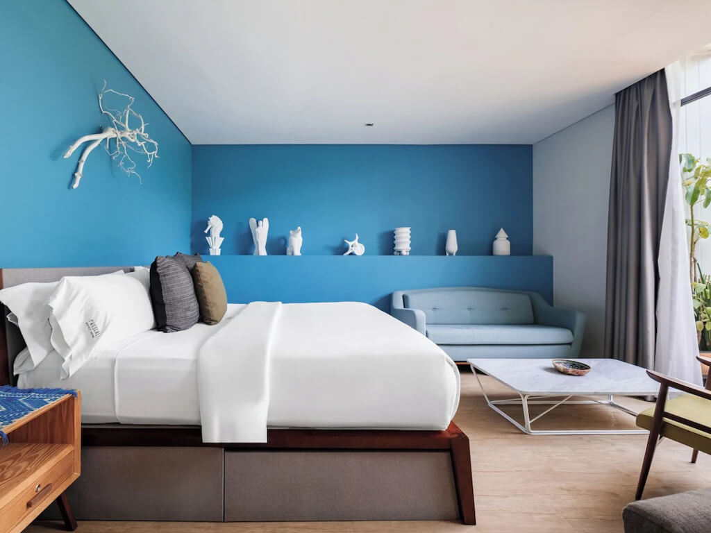 A hotel room with blue colored walls and modern decor in Polanco, one of the best areas to stay in Mexico City.