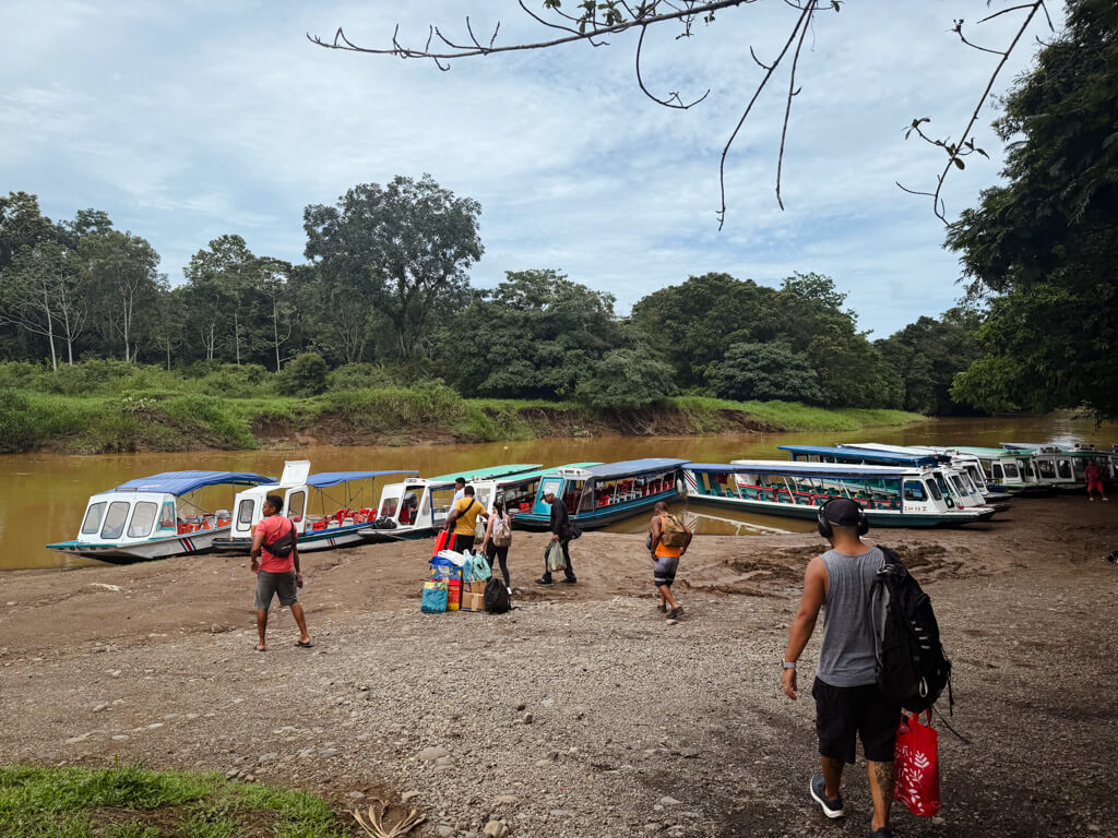 People arriving at the Pavona dock where boats are docked. These boats operate between Pavona and Tortuguero.