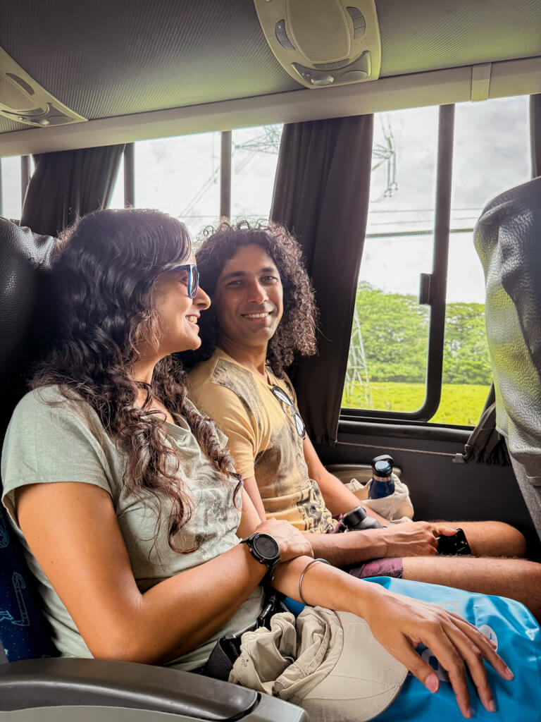 A man and a woman seated inside the bus from San Jose to Cariari. This ride is the first segment of the journey, how to get from San Jose to Tortuguero by bus and boat.