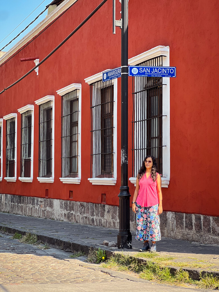 Coyoacan in 2-3 Days. A woman standing in front of a colorful building in San Angel, near Coyoacan, Mexico City.