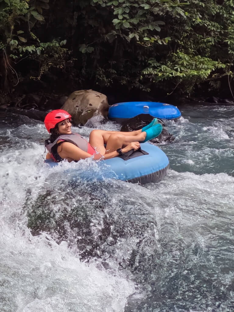 Woman doing river tubing on Rio Celeste in Costa Rica.