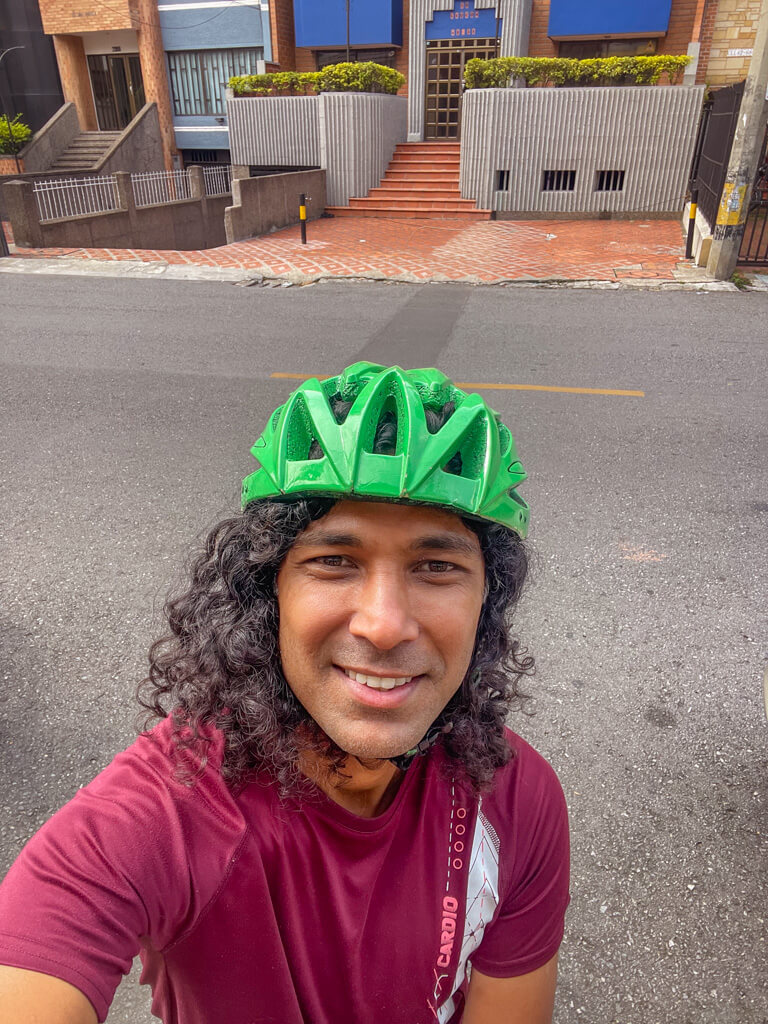 A man wearing a biking helmet in Medellin during a bike tour.