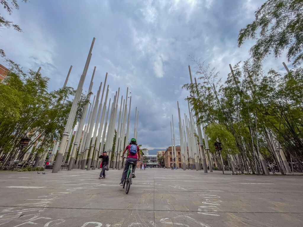 A man cycling through Parque de las Luces in Medellin.