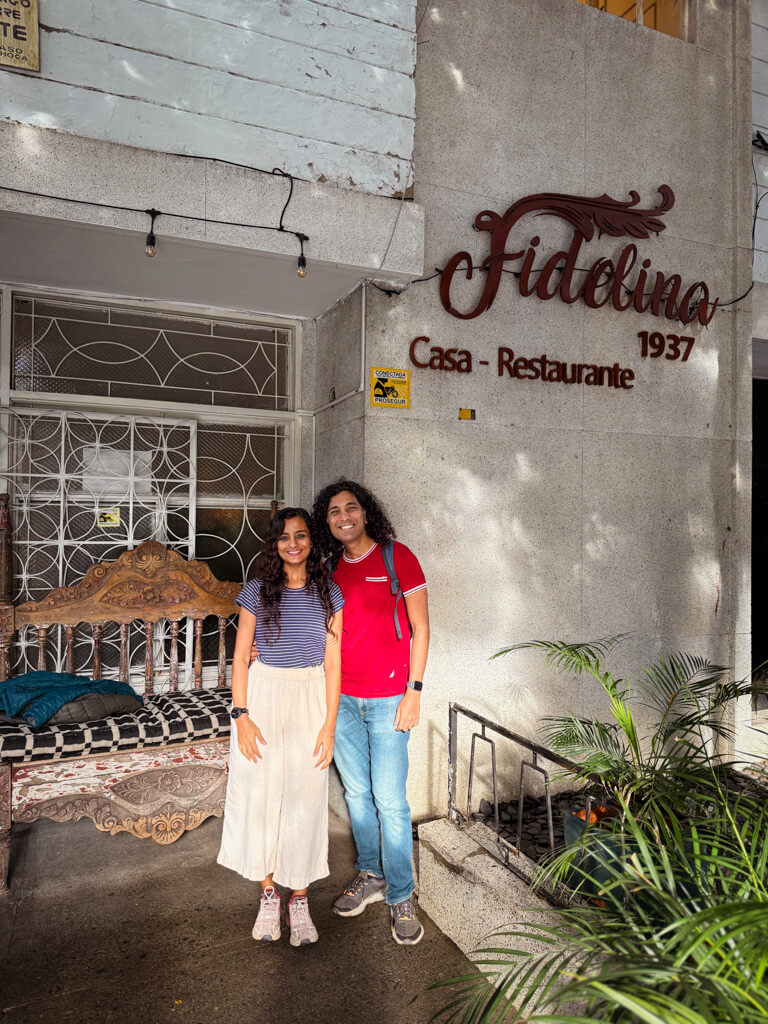 A man and a woman, standing outside a restaurants in Laureles. Part of the Laureles Food Tour.