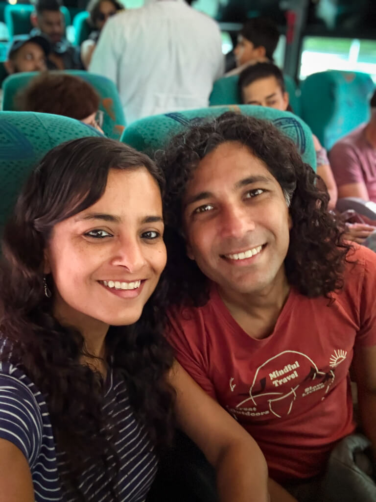 A woman and a man posing for a selfie, seated inside a bus from Medellin to Jardin in Colombia.