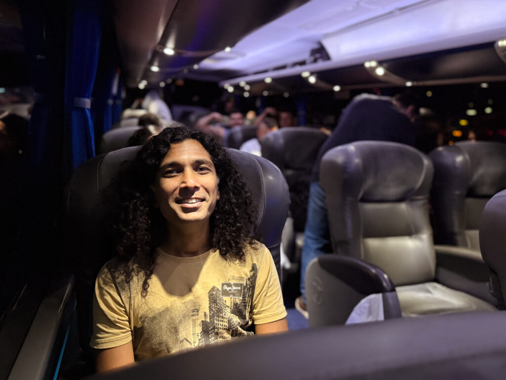 A man sitting on a premium seat in a bus from Medellin to Bogota in Colombia.