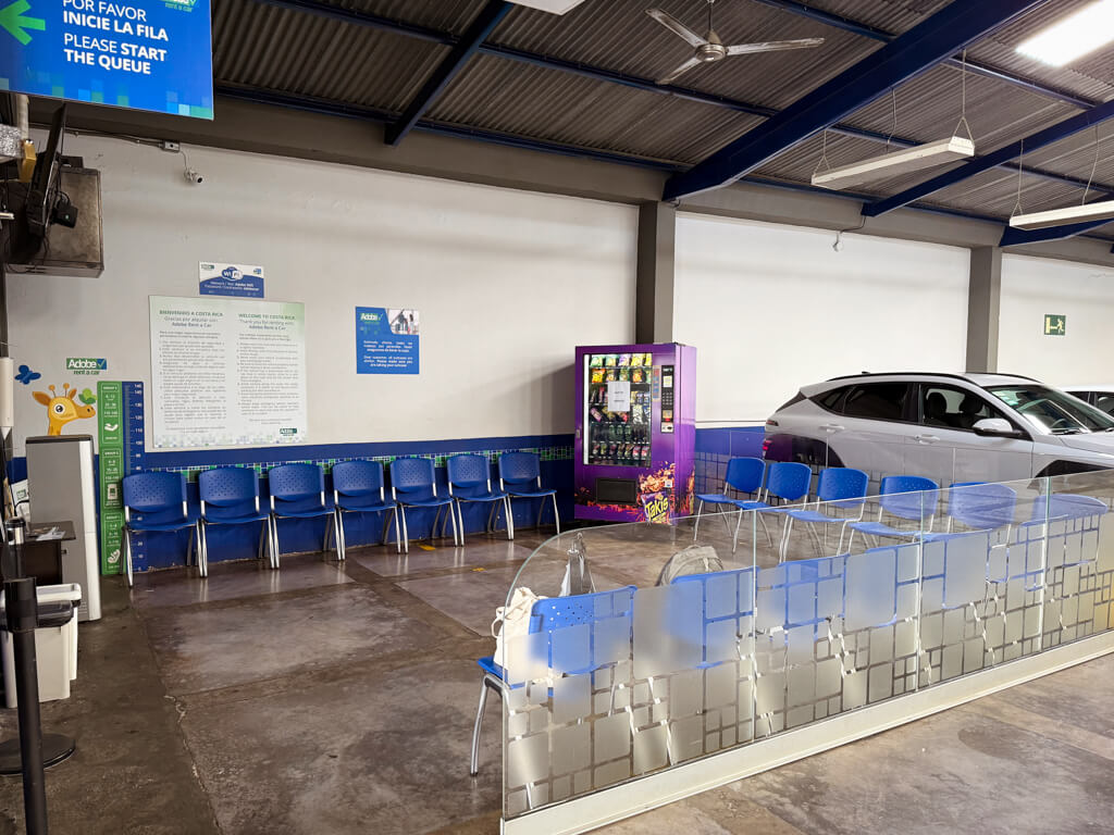The waiting area at Adobe Rent A Car SJO Airport Office.