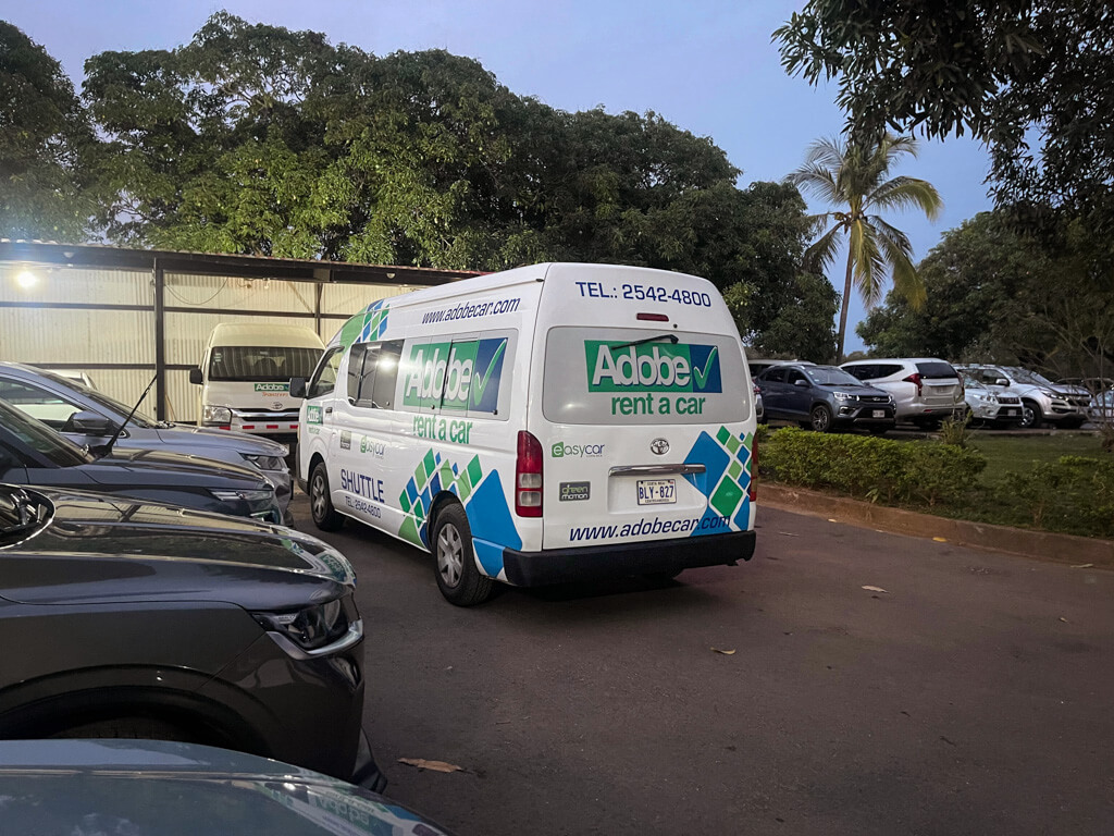 Adobe's Liberia Airport shuttle transfer vehicle, at the parking lot of Adobe Rent A Car Liberia Airport (LIR) office in Costa Rica.