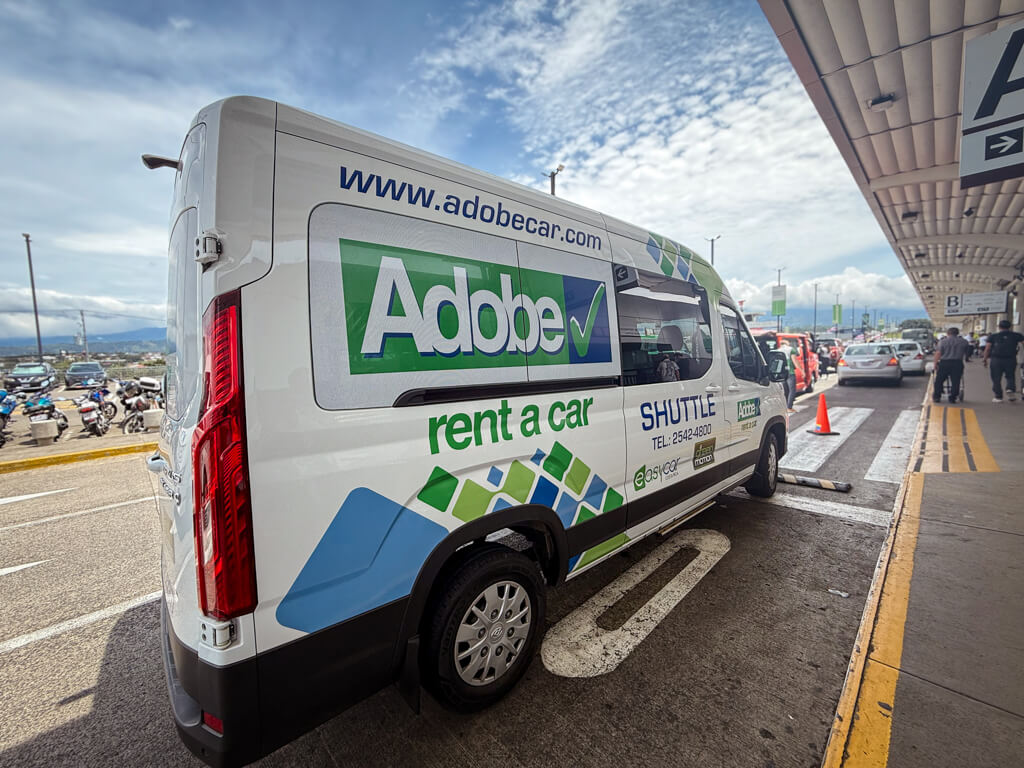 Adobe airport shuttle at the departure terminal of San Jose Airport (SJO), Costa Rica.