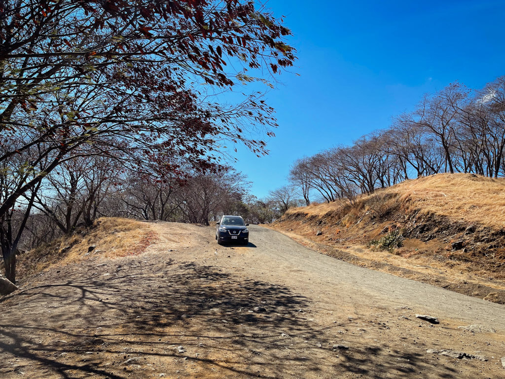 A black SUV on an unpaved mountainous road in Guanacaste, Costa Rica.