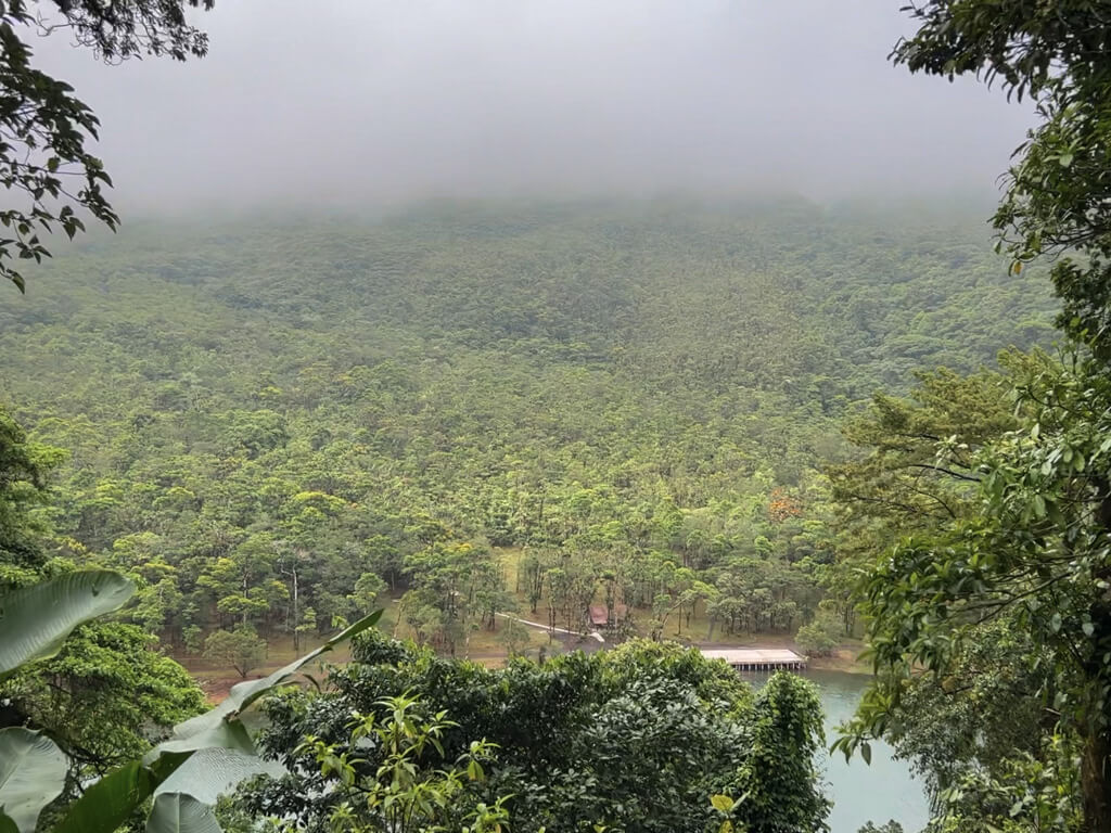 The base of the Arenal Volcano visible from the Los Lagos Mirador. Lake Los Juncos in the foreground.