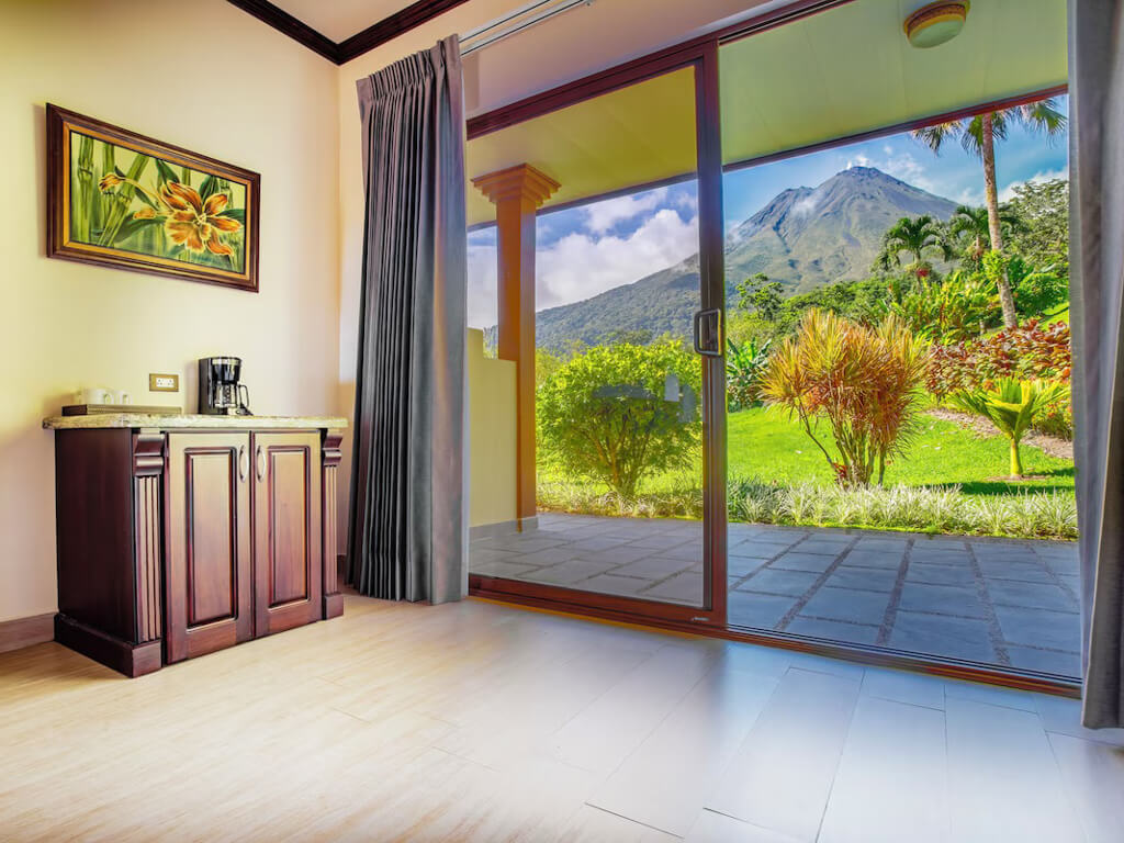 View of Arenal Volcano, seen from inside a room at Los Lagos Hotel Spa & Resort.