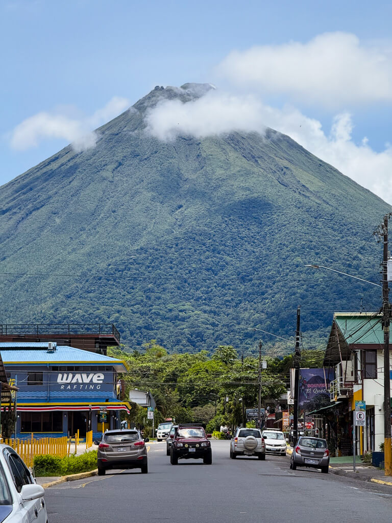 View of Arenal Volcano from La Fortuna town center with bit of cloud near the top.