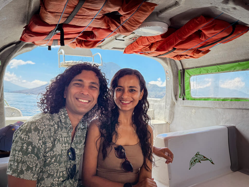 A man and a woman in a boat, on a ride across Lake Atitlan in Guatemala, between San Pedro La Laguna and Panajachel.