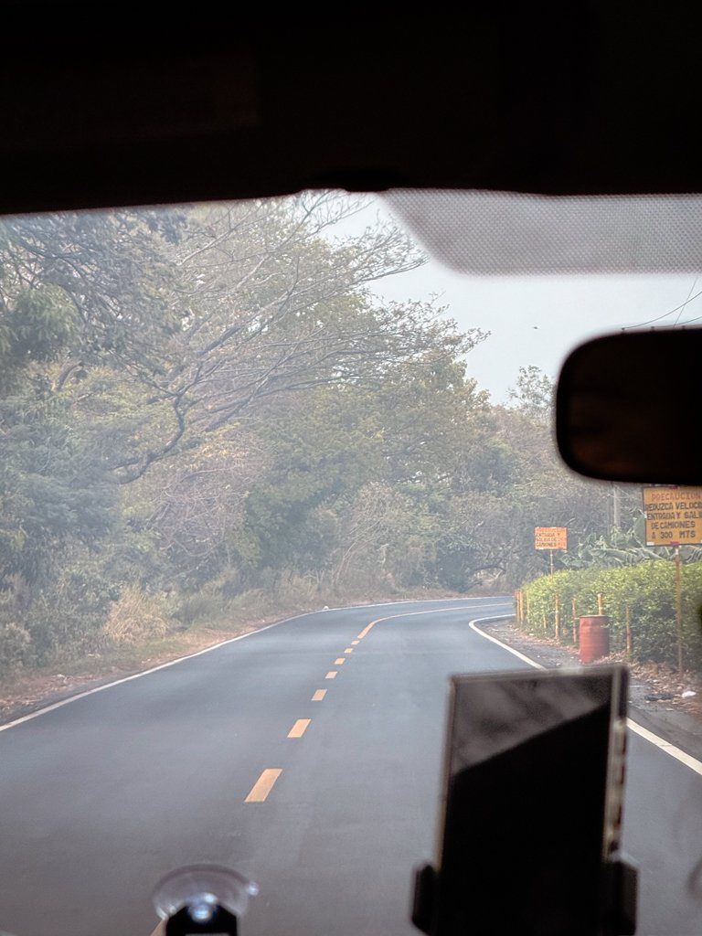 Road from El Paredon to Antigua Guatemala, as seen from inside a shuttle vehicle.
