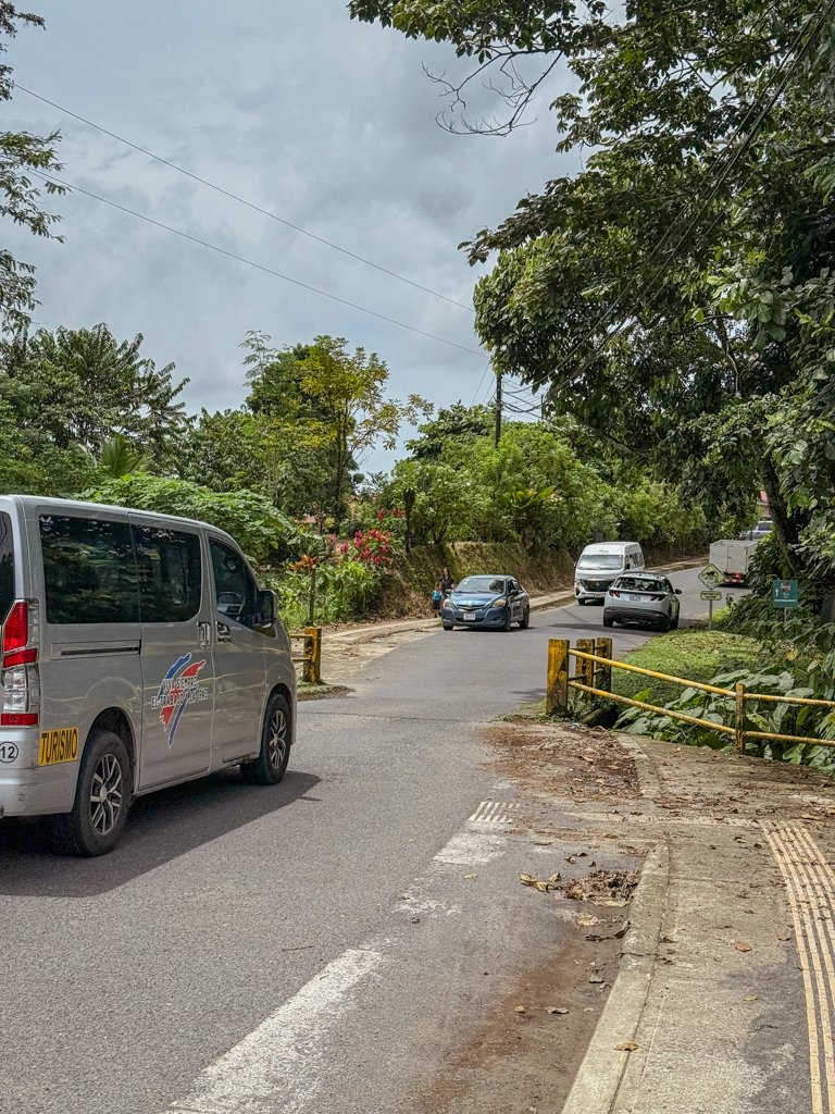 A mini-van crossing a one-way bridge in Costa Rica while the cars from the other side wait their turn to cross the bridge.